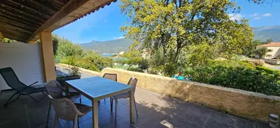 a table and chairs on a patio with a view at T2 Dolce & Vita C3 vue mer et piscine in Propriano