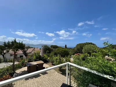a view of the garden from the balcony of a house at Villa le Palmier 10 personnes piscine, vue mer, plage in Olmeto