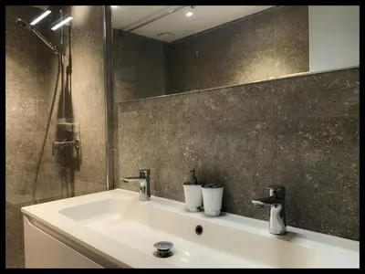 a bathroom with a sink and a mirror at Villa DOLCE, piscine privée chauffée & jacuzzi privatif, 5mn des plages in Porto-Vecchio