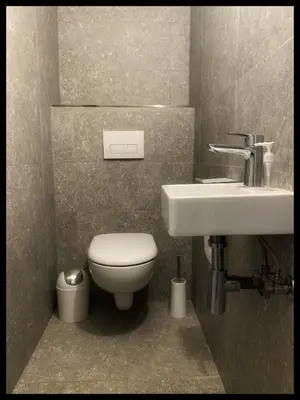 a bathroom with a toilet and a sink at Villa DOLCE, piscine privée chauffée & jacuzzi privatif, 5mn des plages in Porto-Vecchio