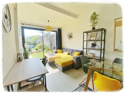 a living room with a couch and a table at Villa DOLCE, piscine privée chauffée & jacuzzi privatif, 5mn des plages in Porto-Vecchio