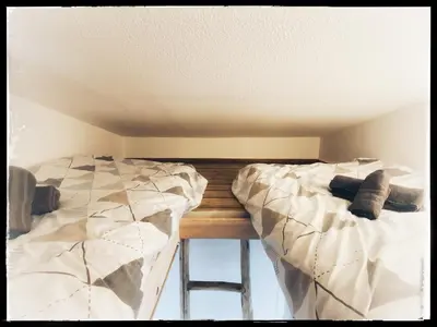 two beds sitting next to each other in a room at Villa DOLCE, piscine privée chauffée & jacuzzi privatif, 5mn des plages in Porto-Vecchio