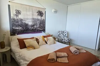 a bedroom with a large bed with towels on it at Bel Appartement climatisé vue imprenable sur la mer terrasse wifi in Serra-di-Ferro