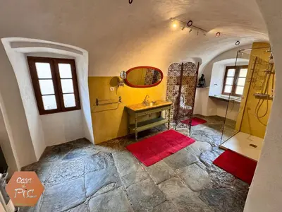 a bathroom with a sink and a mirror at Casa di Pia, demeure Corse du XIXème in Olmeta-di-Tuda