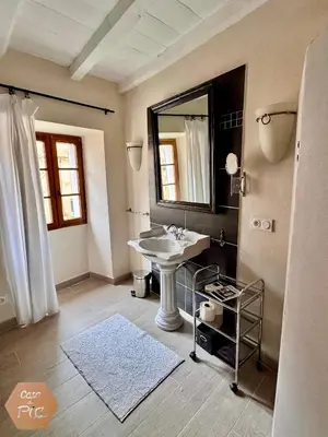 a bathroom with a sink and a mirror at Casa di Pia, demeure Corse du XIXème in Olmeta-di-Tuda