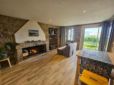 a living room with a fireplace and a couch at Appartement vue imprenable montagne in Serra-di-Scopamene