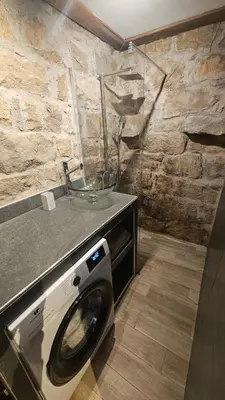 a washing machine with a bowl on top of it in a bathroom at Appartement vue imprenable montagne in Serra-di-Scopamene