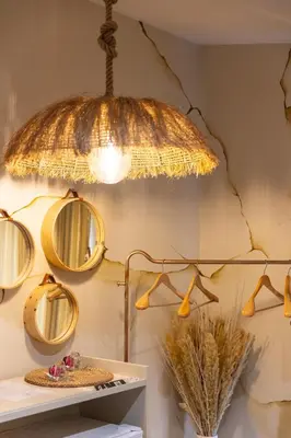 a gold light hanging from a wall with mirrors at Hacienda d Amore in Oletta