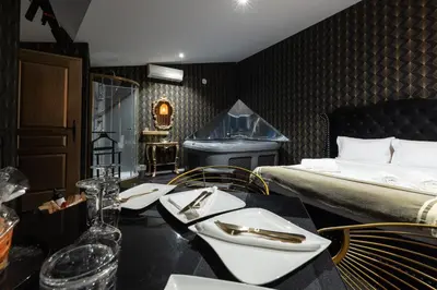 a hotel room with a bed and a table with silverware at Hacienda d Amore in Oletta