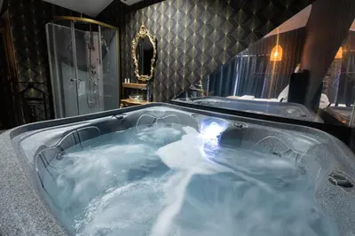 a jacuzzi tub filled with lots of blue water at Hacienda d Amore in Oletta