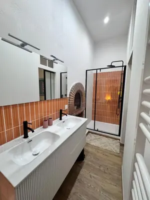 a bathroom with two sinks and a shower at A Casa Grandval - Ajaccio in Ajaccio