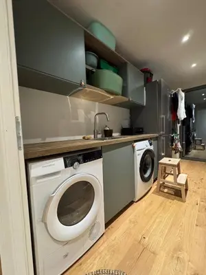 a kitchen with a washing machine and a sink at Bohemian Villa with Heated Pool near beach in Lecci