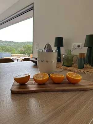 a cutting board with four oranges on a table at Bohemian Villa with Heated Pool near beach in Lecci