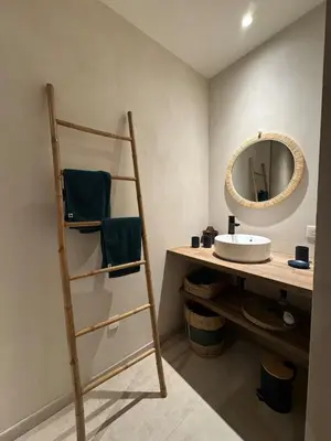 a bathroom with a ladder next to a sink and a mirror at Bohemian Villa with Heated Pool near beach in Lecci