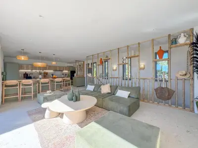 a living room with a couch and a table at Bohemian Villa with Heated Pool near beach in Lecci