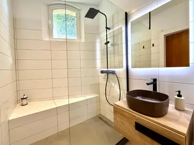 a bathroom with a sink and a shower at Villa Altezza - vue mer 270° in Porto-Vecchio