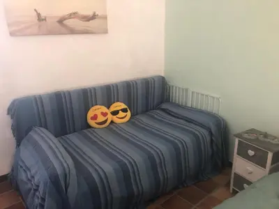 two masks sitting on a bed in a room at Maison familiale vue mer in Grosseto-Prugna