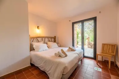 a bedroom with a bed with two towels on it at Villa Rocca Rossa vue exceptionnelle sur la mer in Porto-Vecchio