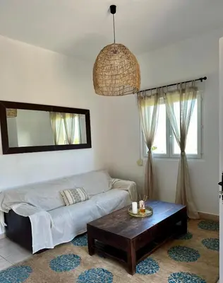 a living room with a bed and a coffee table at Villa haut de gamme vue panoramique exceptionnelle in Porto-Vecchio