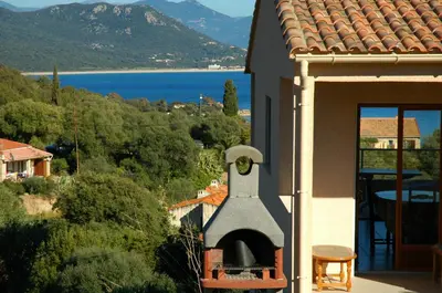 a view of a house with an outdoor oven at Casa Soprana in Porto Pollo