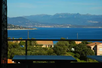 a view of a large body of water from a balcony at Casa Soprana in Porto Pollo