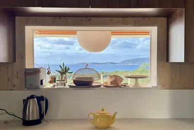 a kitchen window with a view of the ocean at Villa d'architecte à Abbartello, vue mer et accès plage in Olmeto