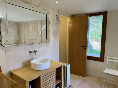 a bathroom with a sink and a mirror at Villa d'architecte à Abbartello, vue mer et accès plage in Olmeto