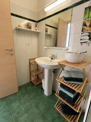 a bathroom with a sink and a mirror at T3 climatisé pour 4 à 6 personnes proche mer en Corse in Linguizzetta