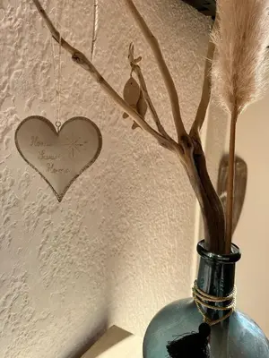 a blue vase with a heart on the wall at T3 climatisé pour 4 à 6 personnes proche mer en Corse in Linguizzetta