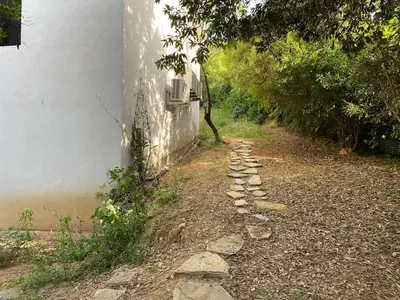 a stone path next to a white building at Isolella à 50 m de la plage in Pietrosella