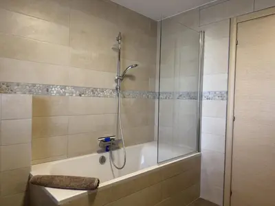 a bathroom with a shower and a bath tub at kaki in Pinarellu