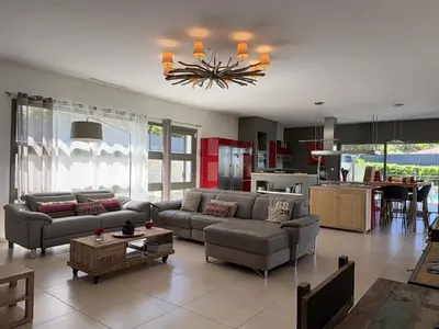 a living room with couches and a kitchen at kaki in Pinarellu