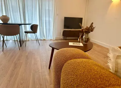 a living room with a couch and a table at Appartement plein centre vue mer PROPRIANO in Propriano