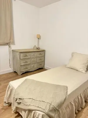 a bedroom with a bed and a dresser at Appartement plein centre vue mer PROPRIANO in Propriano