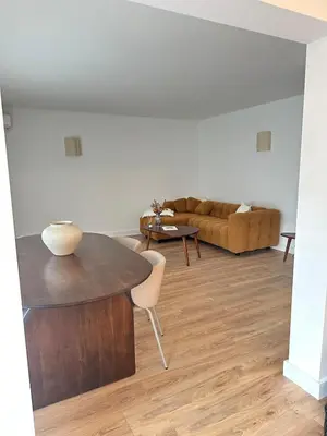 a living room with a table and a couch at Appartement plein centre vue mer PROPRIANO in Propriano