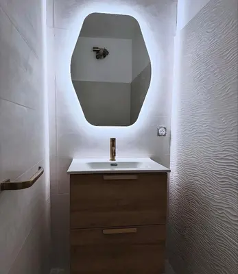 a bathroom with a sink and a mirror at Appartement plein centre vue mer PROPRIANO in Propriano