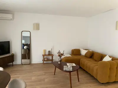a living room with a couch and a table at Appartement plein centre vue mer PROPRIANO in Propriano