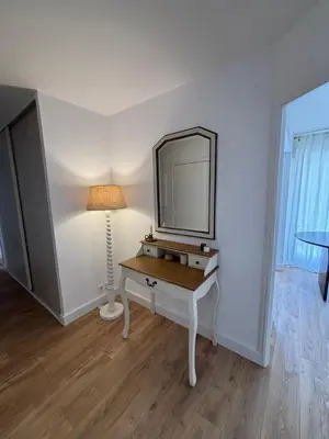 a dressing table with a mirror and a lamp at Appartement plein centre vue mer PROPRIANO in Propriano