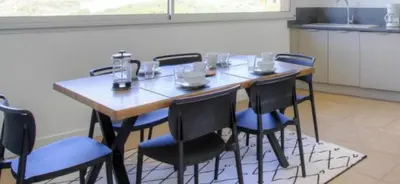 a table in a kitchen with chairs around it at 2Calm in Viggianello