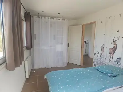 a bedroom with a bed in a room with a window at 2Calm in Viggianello