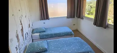 a room with two beds and two windows at 2Calm in Viggianello