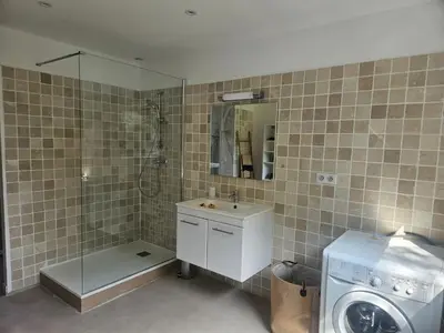 a bathroom with a sink and a washing machine at 2Calm in Viggianello