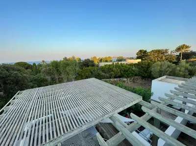a table and chairs sitting on top of a roof at ruscana in Pinarellu