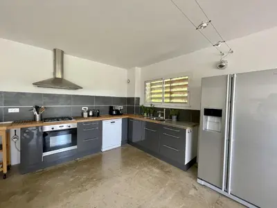 a kitchen with gray cabinets and stainless steel appliances at ruscana in Pinarellu