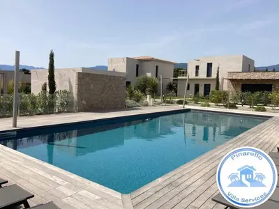 a swimming pool in front of a villa at tianau in Lecci