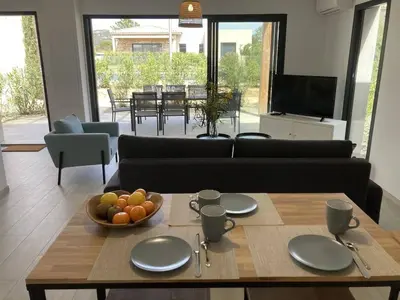 a living room with a table with a bowl of fruit on it at tianau in Lecci