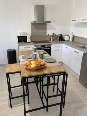 a kitchen with a table with a bowl of fruit on it at tianau in Lecci