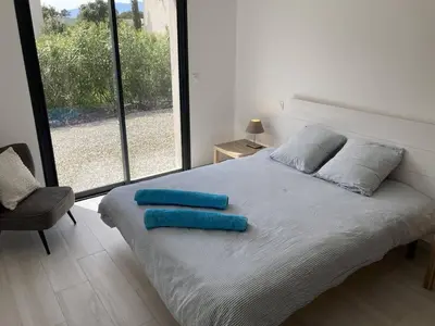 a bedroom with a bed with blue pillows on it at tianau in Lecci