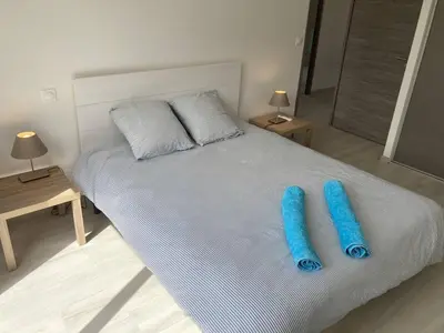 two blue pillows on a bed in a bedroom at tianau in Lecci