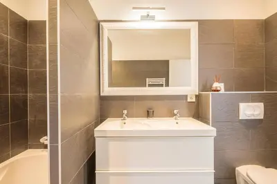 a bathroom with a sink and a mirror and a tub at meli melo in Pinarellu